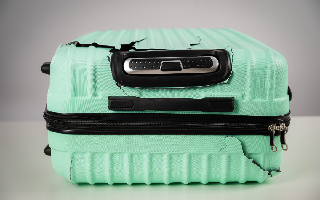 Mint damaged suitcase on a white background.